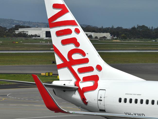 A Boeing 737-800 is seen at the Virgin Australia Airlines terminal at Adelaide Airport in Adelaide, Wednesday, August 28, 2019. Virgin Australia has reported a full-year loss of $349.1 million, saying it will cut 750 corporate and head office positions. (AAP Image/David Mariuz) NO ARCHIVING