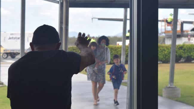 Louis Bezzina waves at his daughter Natalie and grandchildren Maribel and Marcello before they were reunited at Whitsunday Coast Airport today. Picture: Laura Thomas