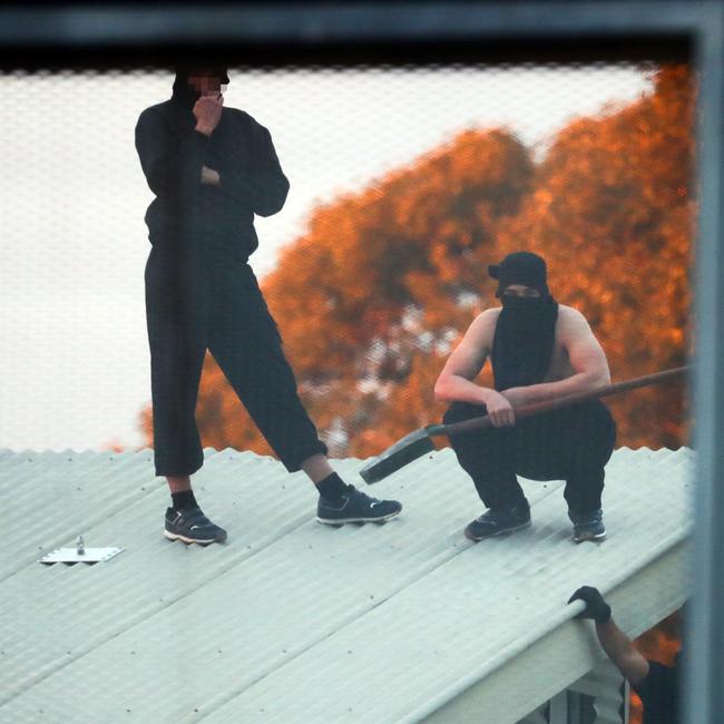 Inmates from the Frank Baxter Juvenile corrections centre Kariong taunt police from the roofs of various buildings. Some are armed with poles tennis rackets ect. Picture: John Grainger
