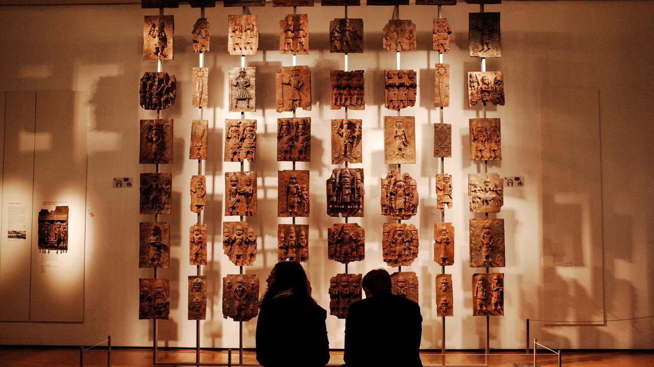 Visitors sit before the contentious Benin bronzes exhibit at the British Museum in London. Picture: David Cliff/SOPA Images/LightRocket via Getty Images