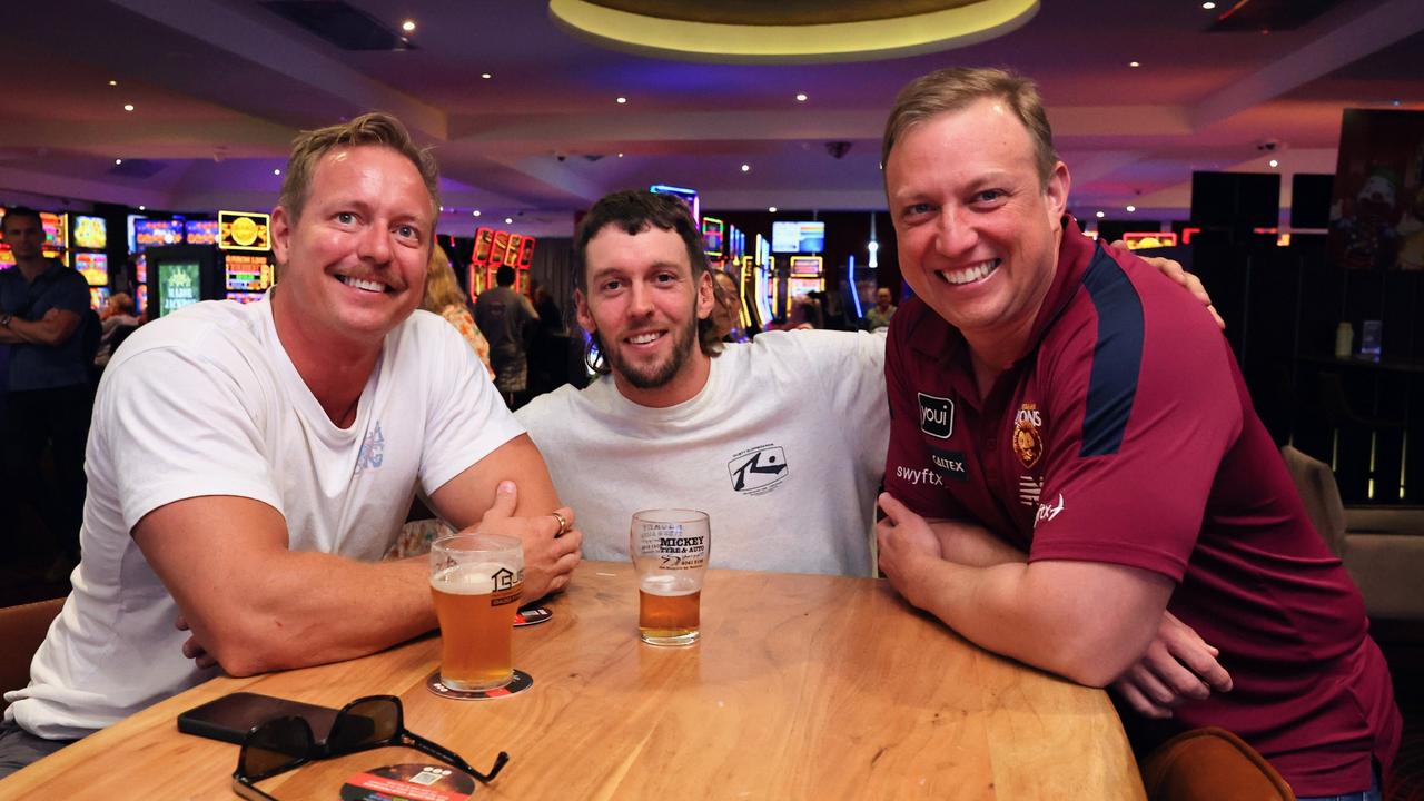 Queensland Premier Steven Miles has a yarn with Cairns locals Nelson Reinaldo and Liam Murphy at Cazalys Sports Club during half time in the 2024 AFL grand final match between the Brisbane Lions and the Sydney Swans. Picture: Brendan Radke