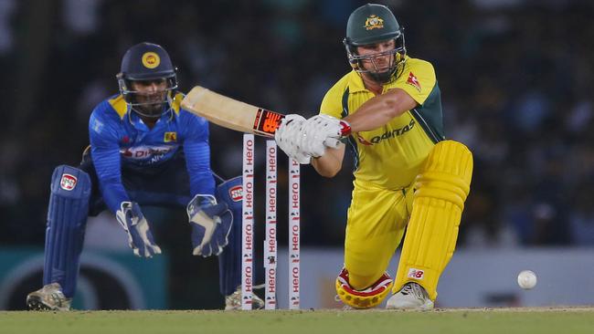 Australia's Aaron Finch plays a shot against Sri Lanka as Kusal Perera watches on from behind the stumps.