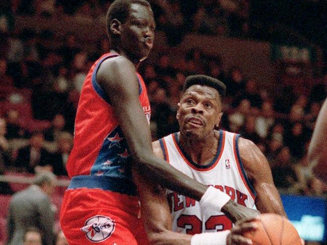 Patrick Ewing, right, is blocked by Philadelphia 76ers' Manute Bol in a 1993 NBA game.