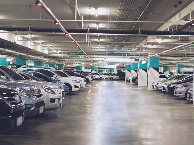 Underground carpark generic .Cars parked in the parking lot.Open space area indoors.