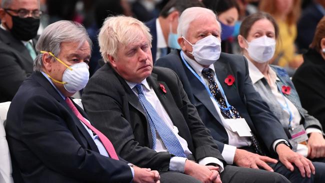 British Prime Minister Boris Johnson, sitting between UN Secretary-General Antonia Guterres and Sir David Attenborough, appears to take five. (Photo by Jeff J Mitchell/Getty Images)