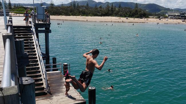 Jayden Coombes from Arrawarra takes the plunge. The weather was on point at the Coffs Harbour Jetty on Boxing Day, 2022. Picture: Chris Knight