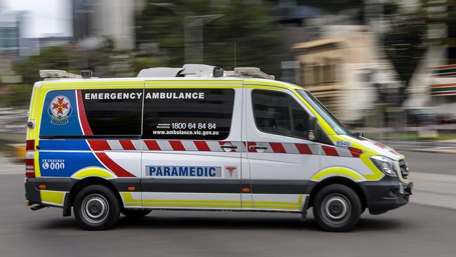 MELBOURNE, AUSTRALIA - NewsWire Photos FEBRUARY 13, 2022: An ambulance speeds away from the Royal Melbourne Hospital. Ambulance, Generic.Picture: NCA NewsWire / David Geraghty