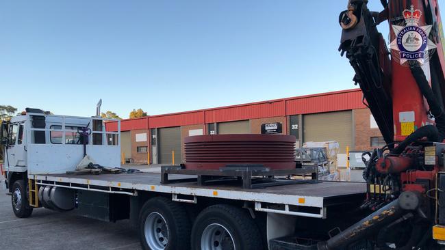 The men and boy were arrested in Wetherill Park after they allegedly attempted to access an inert substance placed in the industrial-sized pulley sent from China. Picture: AFP