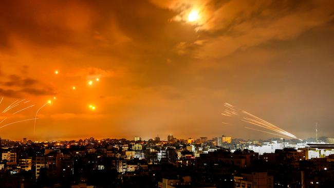 Rockets fired by Palestinian militants from Gaza City are intercepted by the Israeli Iron Dome defence missile system in the early hours of October 8.