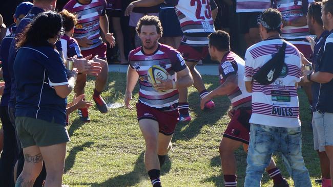 Nerang Bulls captain Josh Edmond leads his team out onto the field. Picture: Adrienne Capie