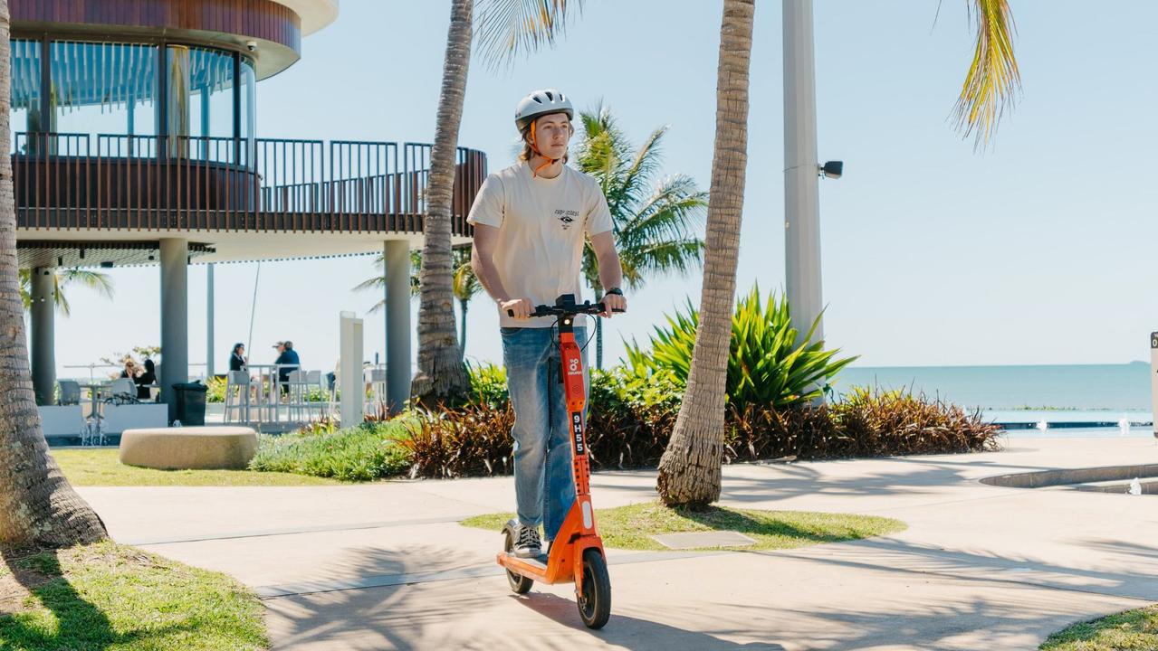 An e-scooter rider enjoys a trip around the picturesque Yeppoon Lagoon.