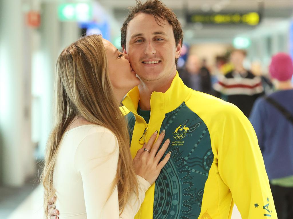 Cam McEvoy, with girlfriend Madeline Bone, got a hero’s welcome as Queensland’s Olympians arrived home via Brisbane Airport. Picture: Liam Kidston