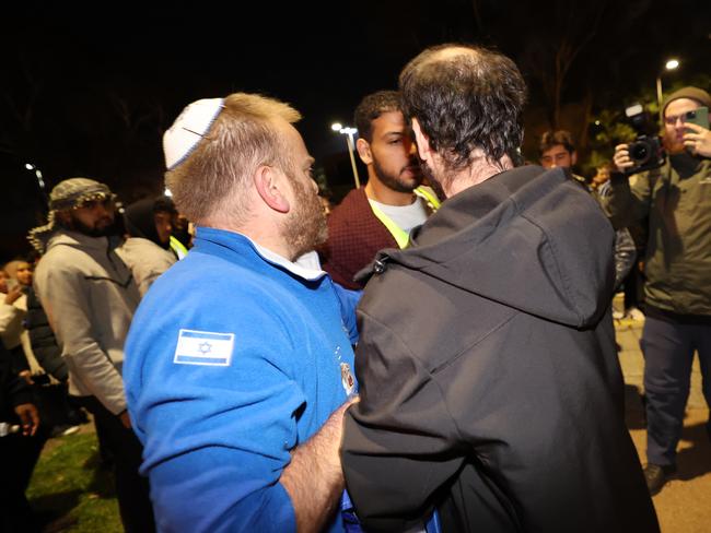 Pro-Palestine protesters set to disrupt Israel event (their Remembrance Day) commemorating war heroes at Monash Uni Clayton. A pro-jewish protester stands too close to the Free Palestine protesters and is covered in a Palestine flag and grabbed by police and returned behind the police line.                     Picture: David Caird