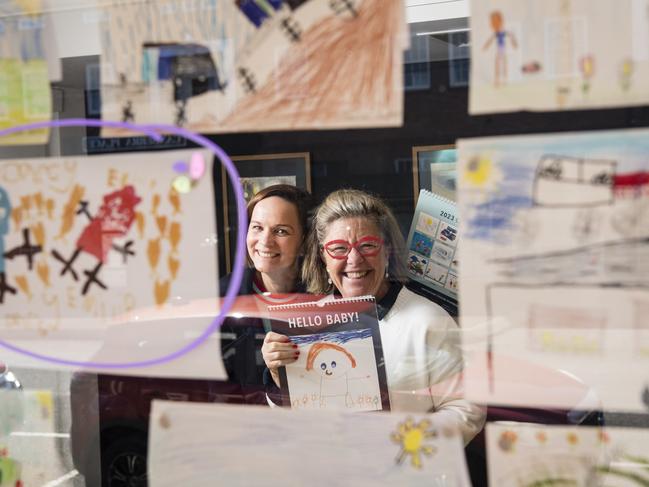 The Lighthouse Toowoomba captain Emily MacManus (left) and lighthouse keeper Emma Mactaggart with Hello Baby! 2023 calendar and entries in the 2024 edition, Thursday, August 10, 2023. Picture: Kevin Farmer