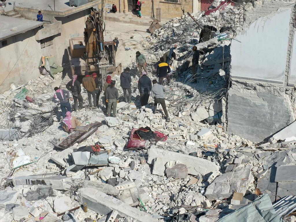 An aerial view shows a digger working on the rubble of a collapsed building in the Syrian rebel-held town of Jindayris. Picture: AFP