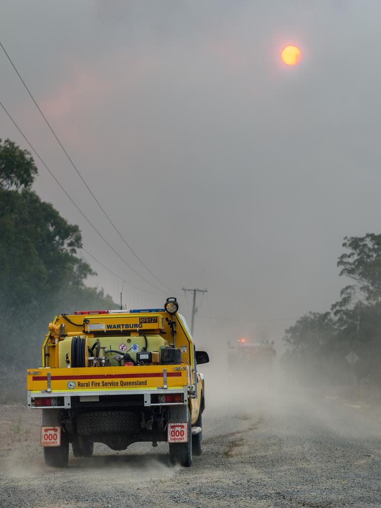 Firefighters head down Pacific Drive in Deepwater. Picture: AAP Image/Paul Beutel