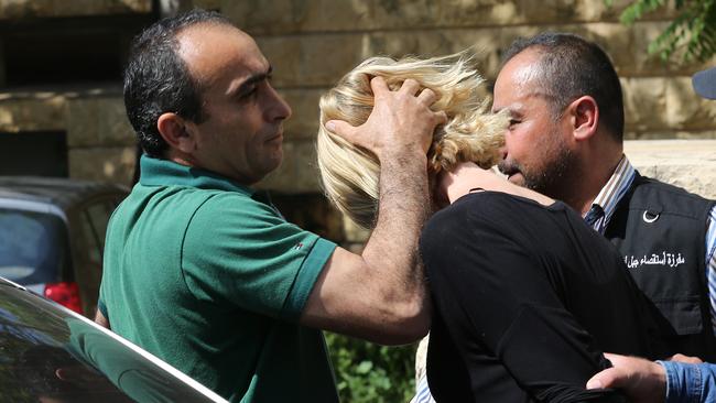 A Lebanese plainclothes policeman prevents Ms Brown from looking towards journalists. Picture: AP