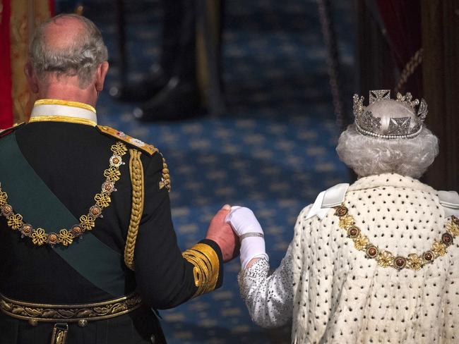 (FILE PIC)  Britain's Queen Elizabeth II (R) leaves with Britain's Prince Charles, Prince of Wales (L) after delivering the Queen's Speech at the State Opening of Parliament in the Houses of Parliament in London on October 14, 2019. - The State Opening of Parliament is where Queen Elizabeth II performs her ceremonial duty of informing parliament about the government's agenda for the coming year in a Queen's Speech. (Photo by Victoria Jones / POOL / AFP)