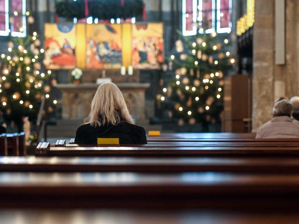 People sit at marked places to keep distance as they take part in a small church service at the St. Marien church in Germany. Picture: AFP