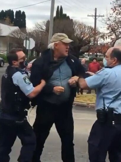 A man is seen being arrested in the video.