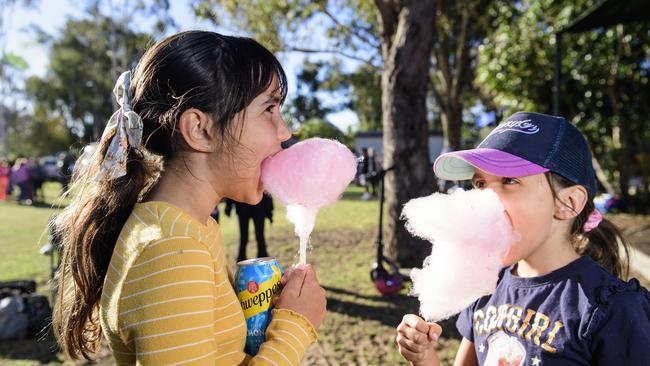 Dixie (left) and Isabella Doomadgee enjoy fairy floss at Sadie's Day Out, a special community event to celebrate the life of five-year-old crash victim Sadie, held at Cambooya State School, Saturday, June 7, 2025. Picture: Kevin Farmer