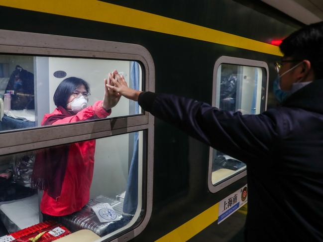 Nurse Wu Lingling farewells husband Zhao Kun before leaving for Wuhan in what has been described as a ‘suicide mission’. Picture: Ding Ting/Xinhua/ZUMA/Australscope