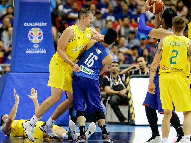 Christopher Goulding (L) lies on the ground as Daniel Kickert (2-L) of Australia elbows Roger Pogoy