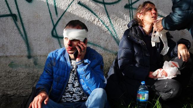 Injured civilians are helped by medics in Kyiv on Monday. Picture: Getty Images