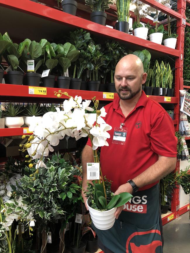 Leigh Streeter with the large white artificial orchid at Bunnings Warehouse Newstead. Picture: Amanda Horswill