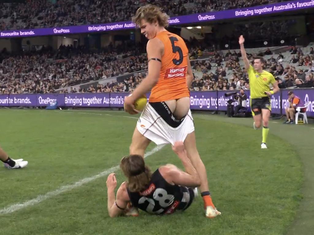 Nathan Murphy pulls down the shorts of the Giants' Aaron Cadman at the MCG. Photo: Fox Footy