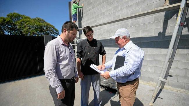 Red Lion Hotel's General Manager Chris Naumann, head chef Chris Carr and owner Rob Carr look over plans for the new beer garden. Picture: Allan Reinikka ROK200318aredlion