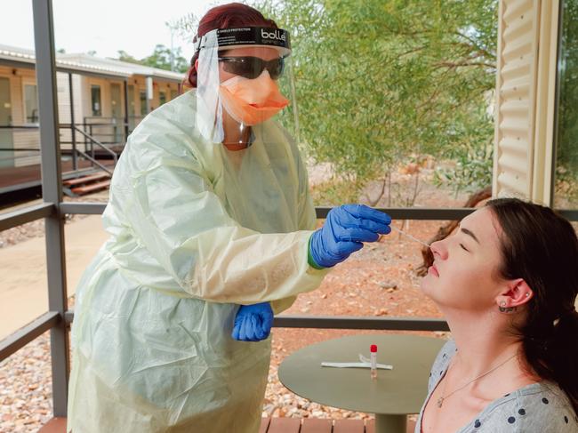 A swabbing team conducting Covid Tests on volunteer Lara Beach at the Howard Springs quarantine facility. Picture Glenn Campbell.