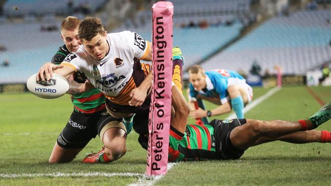 Brisbane winger Corey Oates scores one of his two tries against South Syndey. Picture: Mark Evans