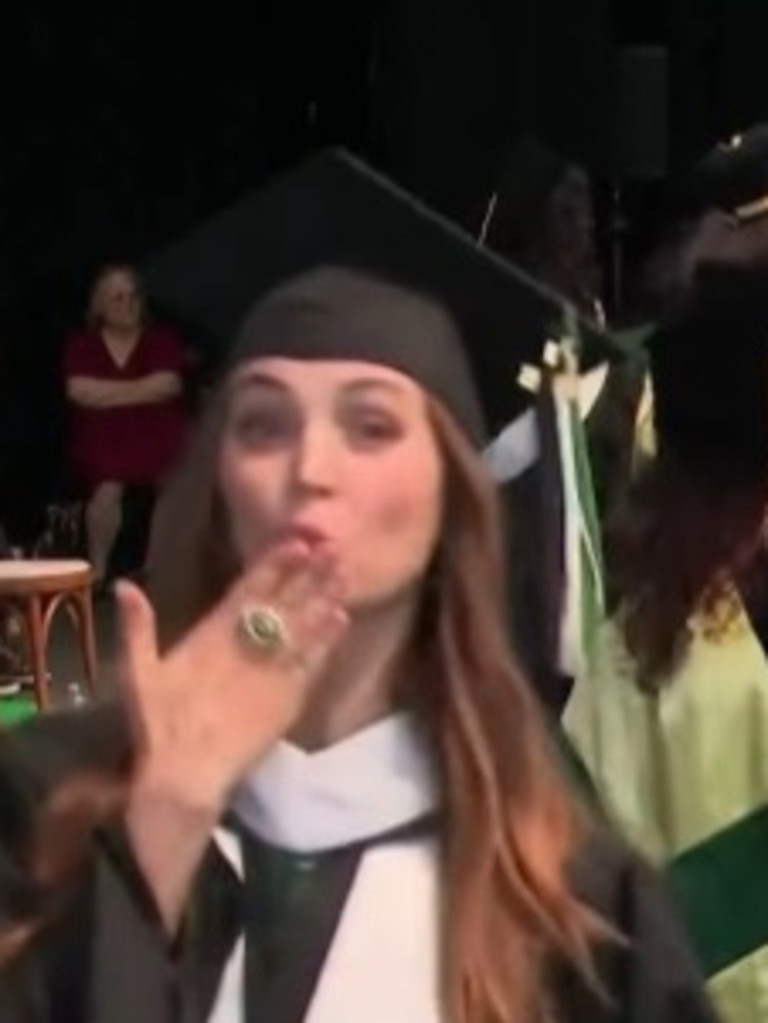 Dushku blows the camera a kiss during graduation.