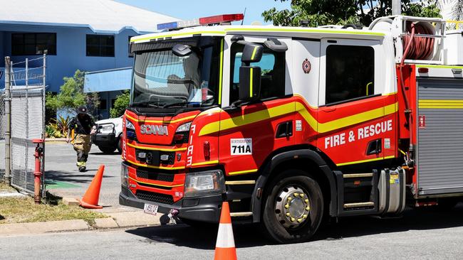 Queensland Fire Department officers respond to an emergency at the General Aviation area of the Cairns Airport, where a man suffered life threatening injuries after being crushed by a car in the carpark of Hinterland Aviation. Picture: Brendan Radke