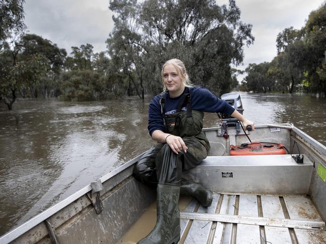 Monday 24th October 2022.  The Australian.Echuca Floods, Victoria.Kiara Dean only 20 years old surveying the damage to her house and her neighbours by boat on Packenham street on the wrong side of the levee.Photograph by Arsineh Houspian.