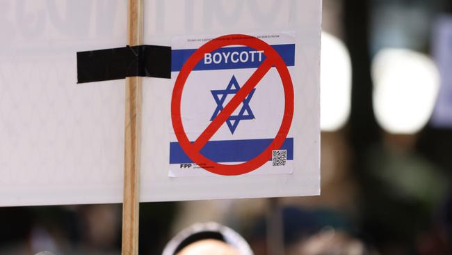 The crossed-out Israeli flag stickers commonly seen in Australian cities, have not constituted any criminal offensive symbol charges. Picture: NewsWire / Damian Shaw