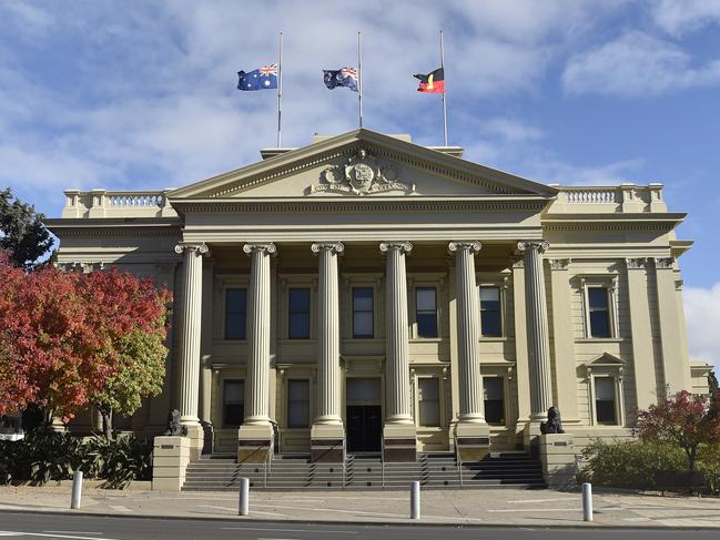 Flags flying half mast at City Hall. Marchers took part in an Anzac Parade through Malop Street to Johnstone Park on Anzac Day. Crowds lined the street but there were none of the usual formalities at the finale. Picture: Alan Barber