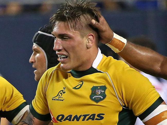 CHICAGO, IL - SEPTEMBER 05: Sean McMahon #7 of the Australia Wallabies (center) is congratulated by teammates after scoring a try against the United States Eagles during a match at Soldier Field on September 5, 2015 in Chicago, Illinois. Australia defeated the United States 47-10. Jonathan Daniel/Getty Images/AFP == FOR NEWSPAPERS, INTERNET, TELCOS & TELEVISION USE ONLY ==