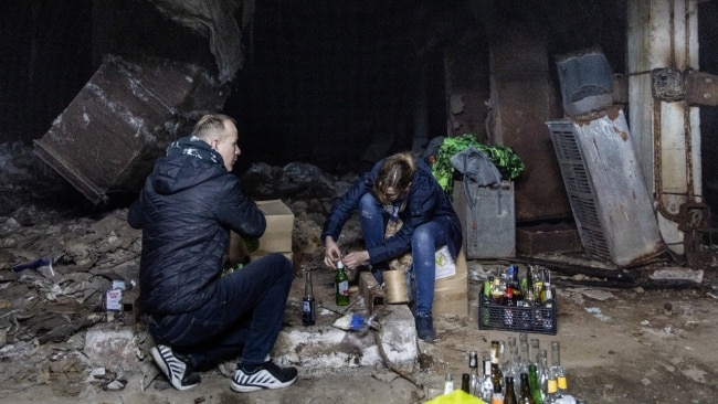 Volunteers make Molotov cocktails in the basement of a bomb shelter in Kyiv. Picture: Getty Images