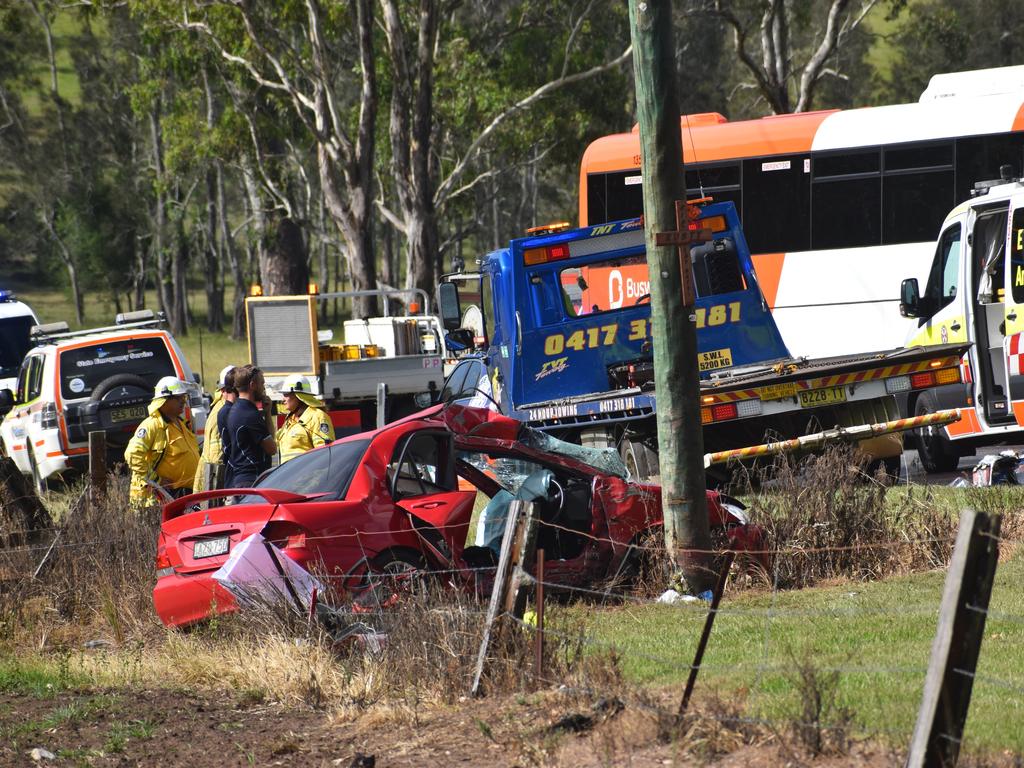 Multiple emergency services crews attended and after-school traffic was blocked after a red sedan Mitsubishi Lancer sedan crashed into a power pole on Rogans Bridge Rd north of Waterview Heights on Thursday, 18th February, 2021. Photo Bill North / The Daily Examiner