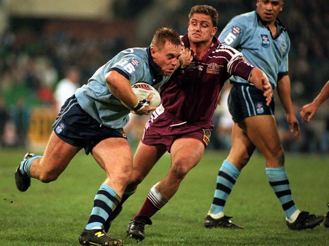 Greg Florimo tries to fend off Billy Moore at the MCG in 1995.