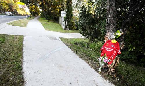 Flowers and a Red Devils Rugby League Club guernsey mark the site where 20-year-old Ben Donohoe lost his life in a car accident on the Bangalow Road at Byron Bay early yesterday morning. . Picture: Cathy Adams