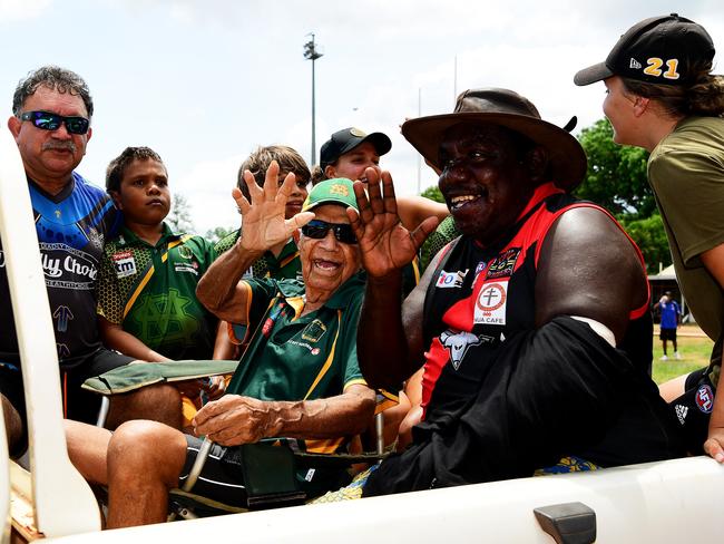 St.Mary's legend Jack Long Sr with friends and family as he does a victory lap around the Tiwi oval on Bathurst Island last year as he was recognised for all of his hard work with AFL in the Top End. Picture: Justin Kennedy