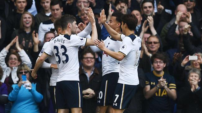 Tottenham Hotspur's Danish midfielder Christian Eriksen (L) celebrates with teammates.