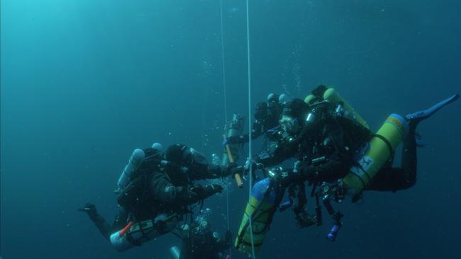 Divers Brad Turner, James Parkinson, and Bob Van Der Velde on a decompression stop after conducting a dive off Tasmania's East Coast.