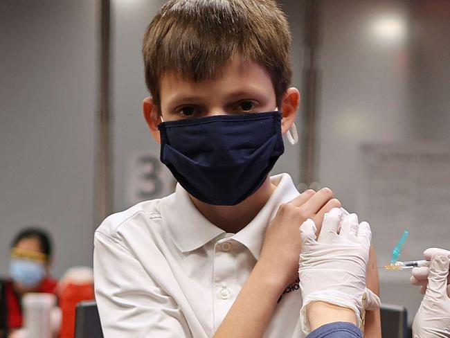 ANNANDALE, VIRGINIA - NOVEMBER 04: A child receives the Pfizer BioNTech COVID-19 vaccination at the Fairfax County Government Center on November 04, 2021 in Annandale, Virginia. The federal government approved the coronavirus vaccine for children between the ages of 5 and 11 this week.   Chip Somodevilla/Getty Images/AFP == FOR NEWSPAPERS, INTERNET, TELCOS & TELEVISION USE ONLY ==