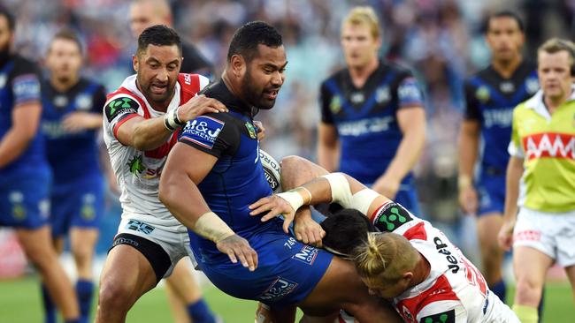 Tony Williams (centre) of the Bulldogs is tackled by Benji Marshall (left) and Jake de Belin of the Dragons during the round 14 NRL match between the St George Illawarra Dragons and the Canterbury-Bankstown Bulldogs.