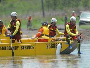 FLASHBACK: Queensland Fire & Rescue Swift Water Rescue Team at location of a submerged utility preparin to secure the vehicle. Picture: MARTINELLI DAVID