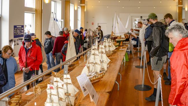 Visitors examine model boats at the Australian Wooden Boat Festival. Picture: Tim Kingston, BALLANTYNE Photography/AWBF